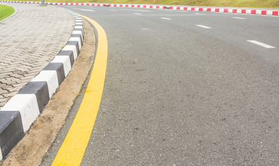 Asphalt road texture with yellow stripe