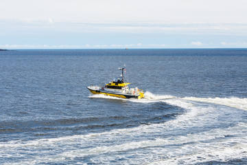 Yellow Pilot Boat Curving Through Water
