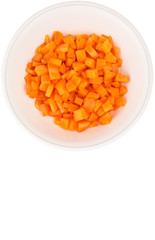 Chopped carrot in a bowl over white background
