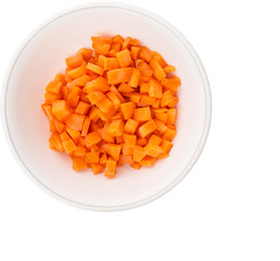 Chopped carrot in a bowl over white background