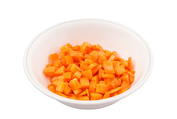 Chopped carrot in a bowl over white background