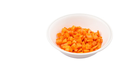 Chopped carrot in a bowl over white background