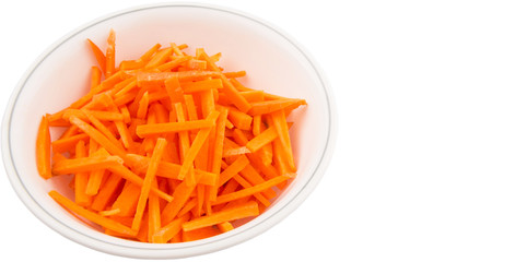 Chopped carrot in a bowl over white background