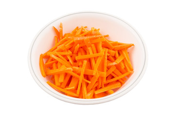 Chopped carrot in a bowl over white background