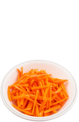 Chopped carrot in a bowl over white background