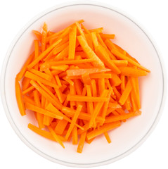 Chopped carrot in a bowl over white background