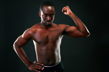 Fototapeta na wymiar Strong young man showing his muscular