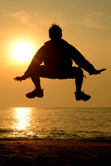 Naklejka premium Silhouette happy person jumping Spider man action