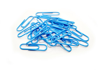 Scattered Light Blue Paperclips Over White