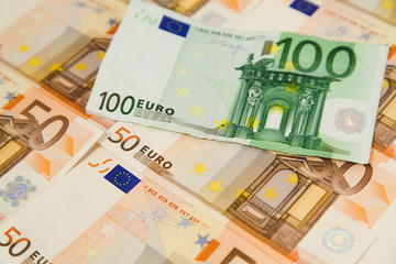 One hundred euro banknote on money background