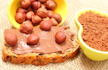 Hazelnut and slices of bread with chocolate cream