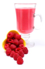 Fresh raspberries pouring out of yellow bowl and fresh cocktail