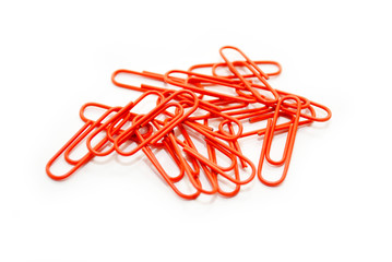 Scattered Orange Paper Clips on a White Background
