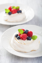 pavlova meringue cake with cream and berry