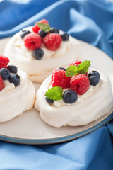 pavlova meringue cake with cream and berry