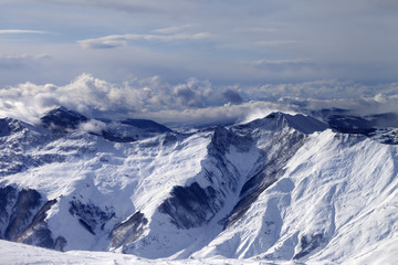 Winter mountains in clouds at windy day