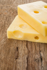 Yellow cheese wooden background