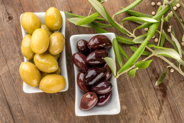Different olive fruits wooden background
