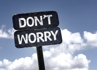 Don't Worry sign with clouds and sky background