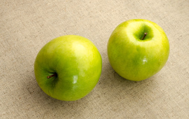 two green apple lying on a  table