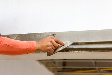 plasterer concrete on wall of house construction