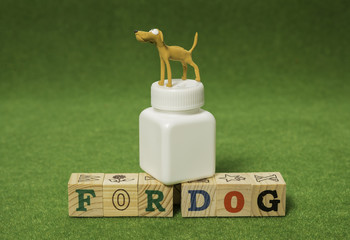 Clay brown dog stand on white medicine bottle