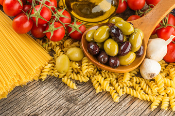 Pasta olives  tomato wooden table