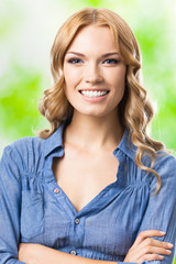 Happy smiling woman with long hair, outdoor