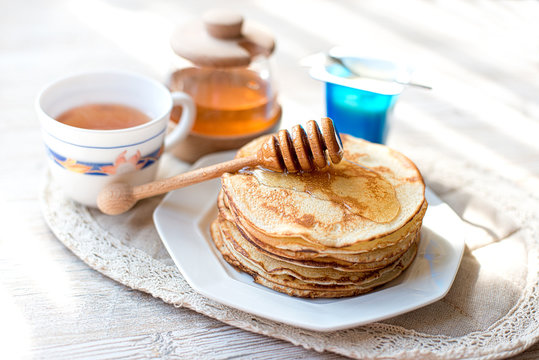 Pancakes with honey on the kitchen table