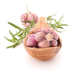 Garlic cloves in wooden bowl isolated on white background