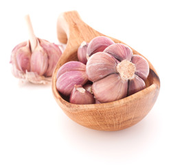 Garlic cloves in wooden bowl isolated on white background