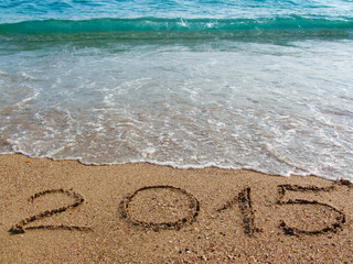 2015 written on sandy beach.