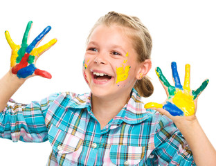 Portrait of a cute girl playing with paints