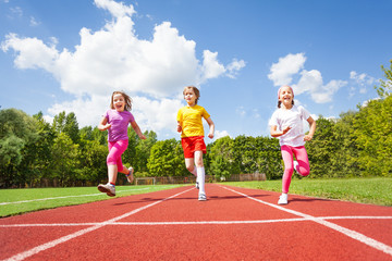 Smiling children running marathon together