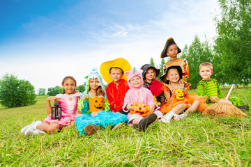 Children in Halloween costumes sit together