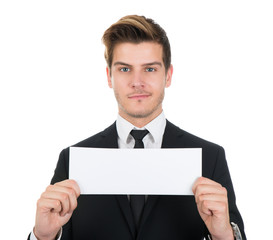 Portrait Of Confident Businessman Holding Blank Sign