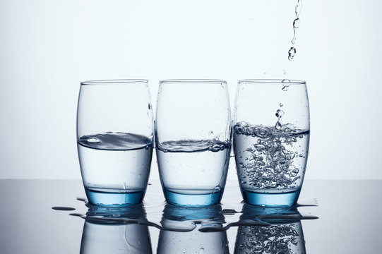 Pouring Water In Three Water Glasses