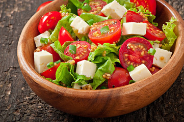 Tomato salad with lettuce, cheese and mustard and garlic dressin