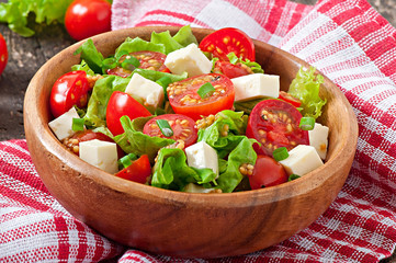 Tomato salad with lettuce, cheese and mustard and garlic dressin