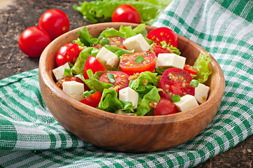 Tomato salad with lettuce, cheese and mustard and garlic dressin