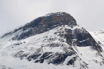 Fototapeta na wymiar One tall peak of the Alpine mountains