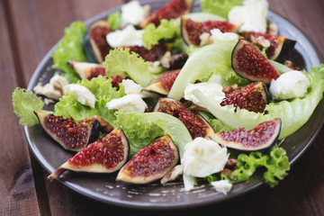 Fig fruits, cheese and walnuts salad, close-up, horizontal shot