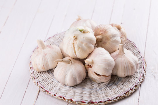Garlic on wooden background.