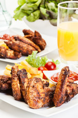 Chicken wings with fries french and spicy sauce