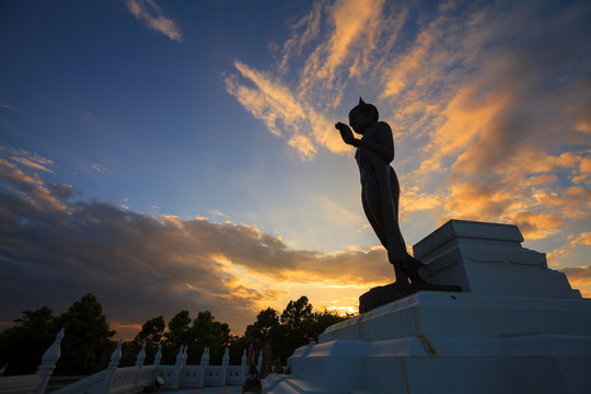 Standing Buddha image silhouette on sunset sky. in Phitsanulok,