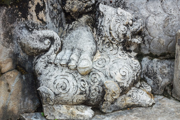 statue of human foot on lion in literature