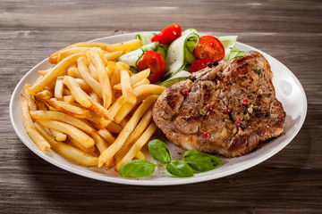 Grilled steak, French fries and vegetables