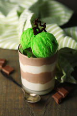 Tasty chocolate mousse with sorbet on wooden table