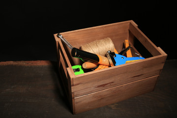 Wooden box with different tools,