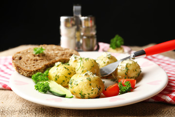 Young boiled potatoes on table, close up